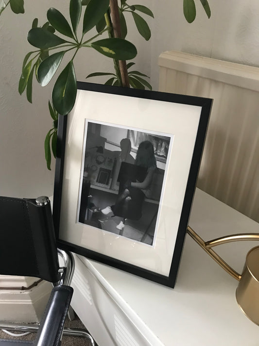 0021 - At the bus stop. Hand printed photograph.